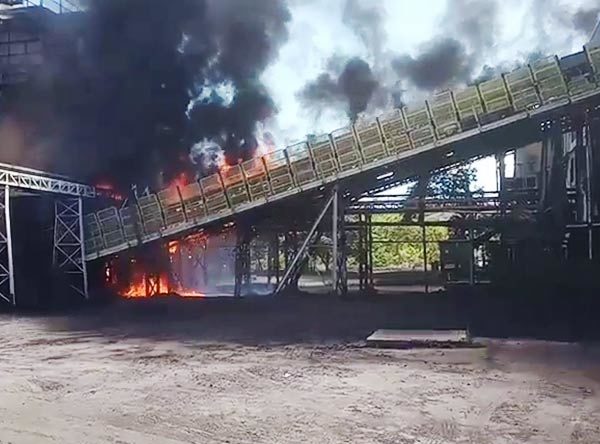 Fire on a conveyor belt transporting petroleum coke
