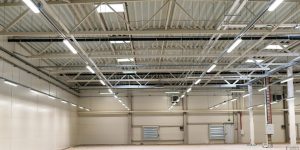 Emergency lighting with dual-function fixtures in a storage area